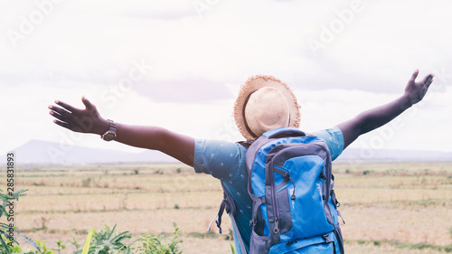 Freedom African tourist traveler man with backpack on view of mountain background.16:9 style