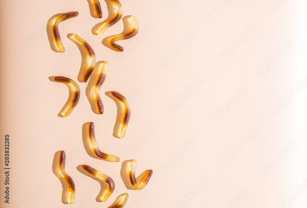Halloween jello worms candies on apricot background Halloween jello worms candies on apricot background