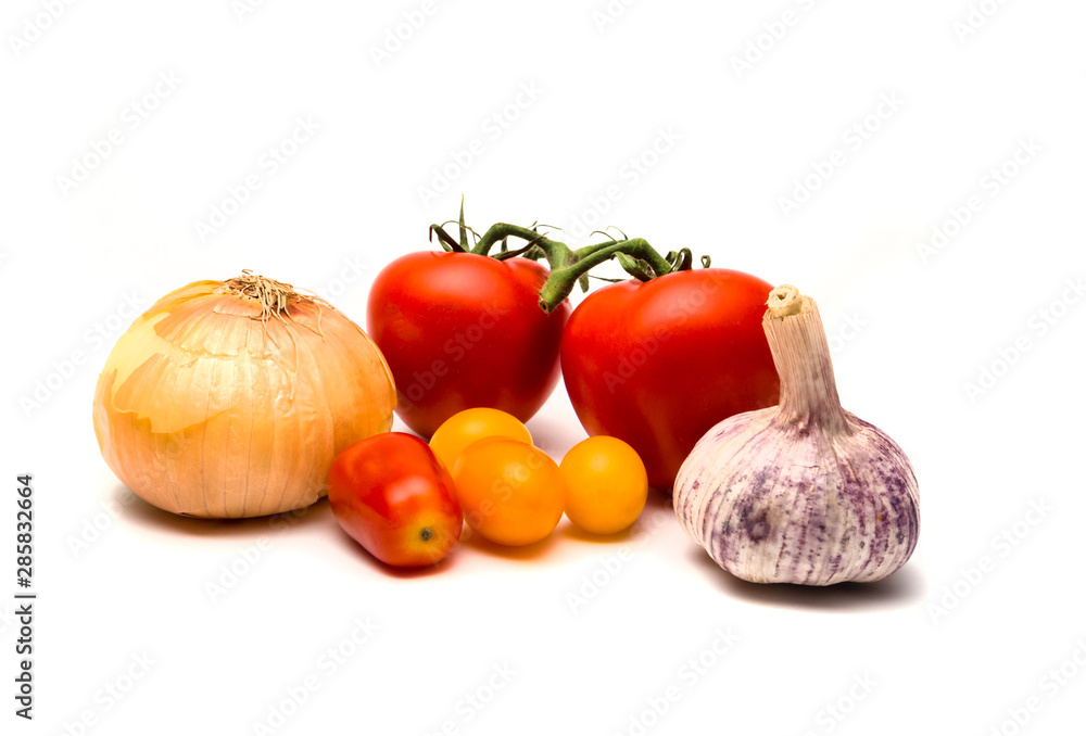 Onion, garlic and tomatoes isolated on white. Onion, garlic and tomatoes isolated on white.