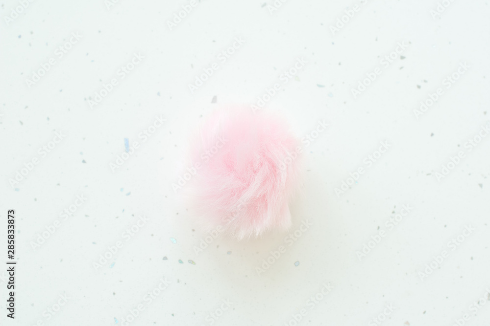 Beautiful shaggy pink feather on white background