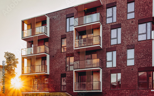 Fototapeta Naklejka Na Ścianę i Meble -  EU Modern new apartment house home real estate outdoor sunset