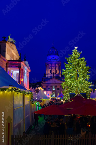 Tourists at Night Christmas market in Gendarmenmarkt in Berlin