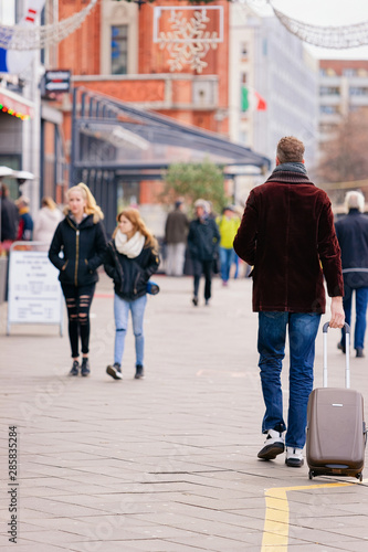 Man with luggage bag in Street in Berlin Mitte