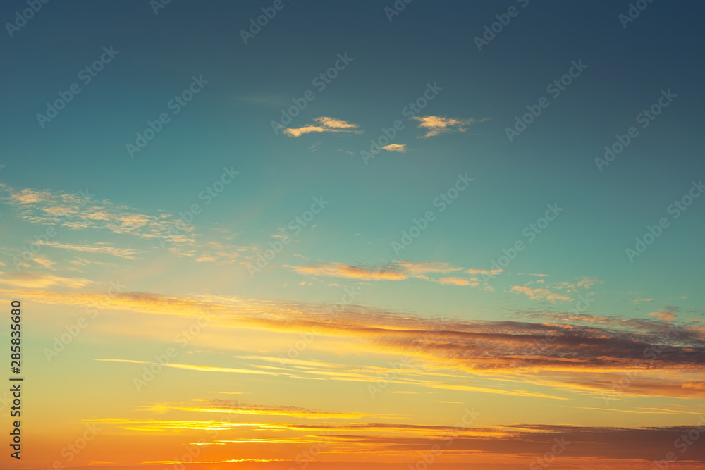 Dramatic colorful sunset or sunrise sky landscape. Natural beautiful dawn background wallpaper. Twilight time cloudscape