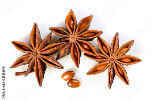 Star anise. Three star anise fruits with two seeds. Macro close up Isolated on white background with shadow, top view of chinese badiane spice or Illicium verum.