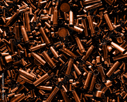Different size bullet shells on the black ground. War concept. production of ammunition at the factory. brass bullet shell, ammunition manufacturing process