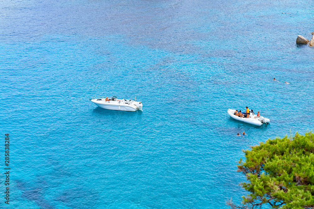 Boats in blue Mediterranian Sea in Capo Testa