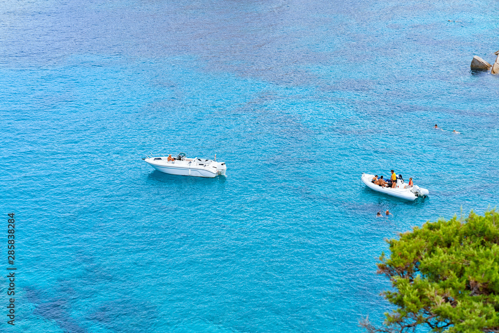 Boats in blue Mediterranian Sea in Capo Testa Boats in blue Mediterranian Sea in Capo Testa
