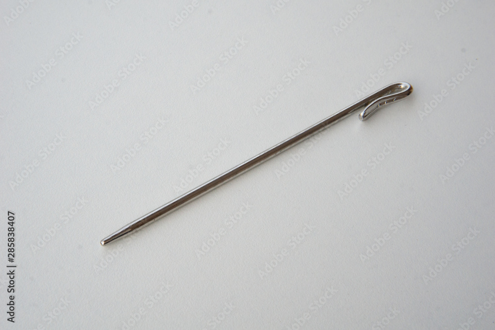 Needle like metal object isolated on white background. This can be used for sewing as well as tidying hair for Sikh boys and men. Needle like metal object isolated on white background. This can be used for sewing as well as tidying hair for Sikh boys and men.