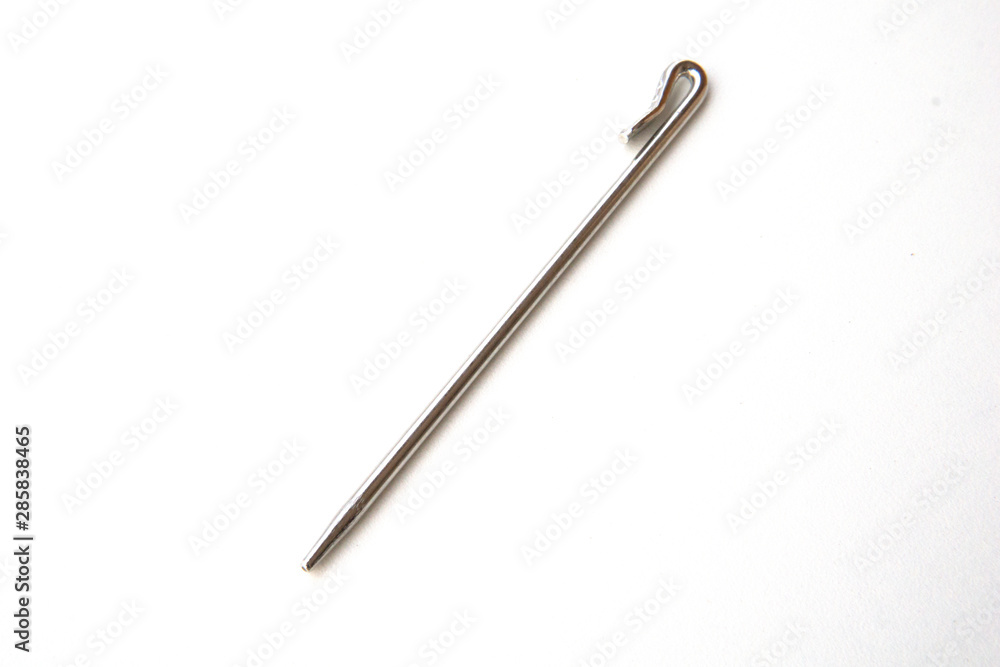 Needle like metal object isolated on white background. This can be used for sewing as well as tidying hair for Sikh boys and men. Needle like metal object isolated on white background. This can be used for sewing as well as tidying hair for Sikh boys and men.