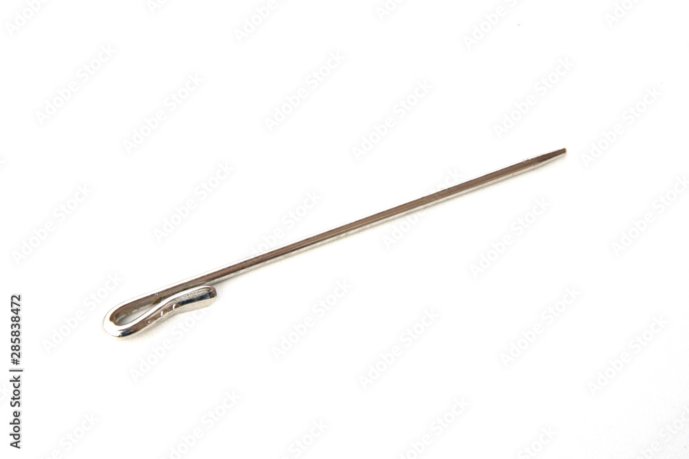Needle like metal object isolated on white background. This can be used for sewing as well as tidying hair for Sikh boys and men. Needle like metal object isolated on white background. This can be used for sewing as well as tidying hair for Sikh boys and men.