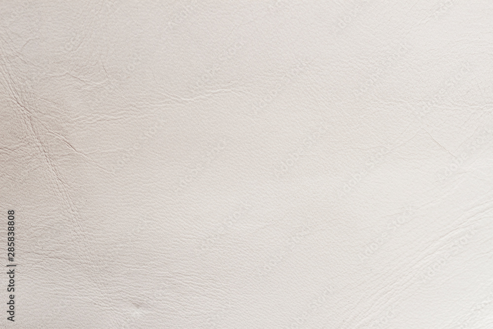 Texture of genuine leather close-up, surface close-up with wrinkles and cracks, cream color print, trendy background Texture of genuine leather close-up, surface close-up with wrinkles and cracks, cream color print, trendy background