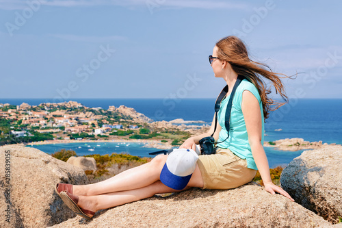 Woman looking at rocks at Capo Testa Sardinia photo