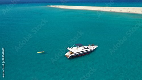 Aerial drone photo of luxury yacht docked in tropical Caribbean bay with turquoise open ocean sea © aerial-drone