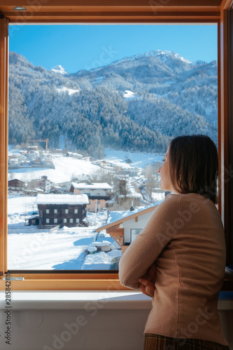 Happy woman in sunglasses at balcony looking houses Zillertal