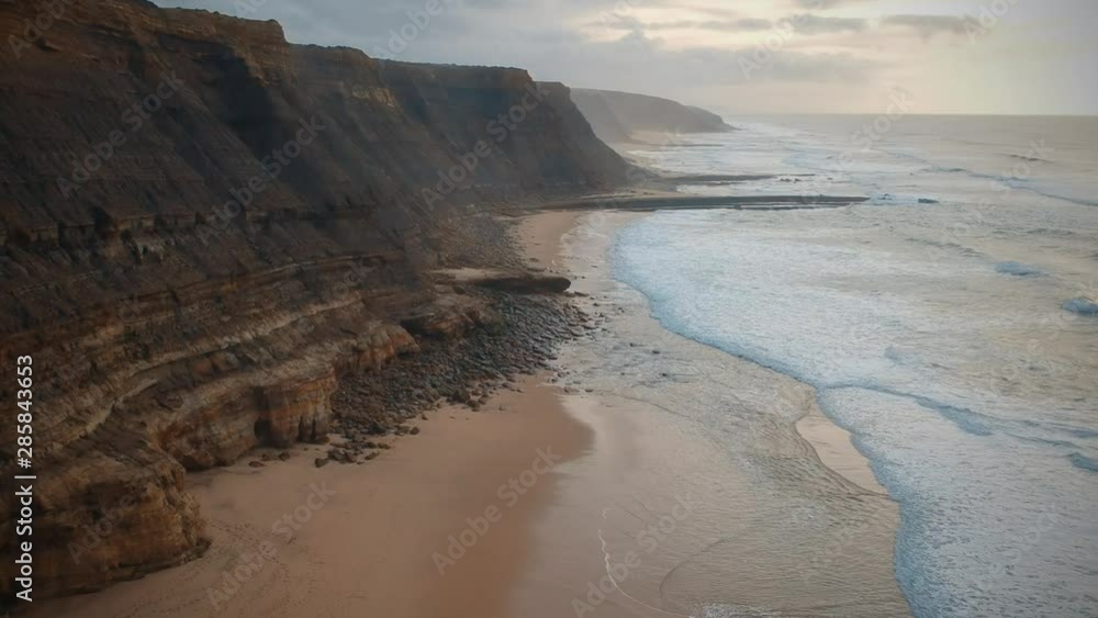 Aerial view of the Sao Juliao beach in Sintra, Portugal. Beach of Atlantic ocean with high cliffs of coastline. Drone view Aerial view of the Sao Juliao beach in Sintra, Portugal. Beach of Atlantic ocean with high cliffs of coastline. Drone view