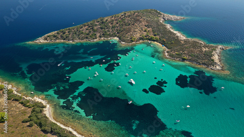 Fototapeta Naklejka Na Ścianę i Meble -  Aerial drone panoramic photo of iconic exotic bay known as blue lagoon in Diaporos island with turquoise clear sea, Vourvourou, Sithonia Peninsula, Halkidiki, North Greece