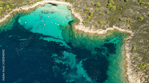 Aerial drone photo of iconic exotic sandy beach known as white beach in Diaporos island with turquoise clear sea, Vourvourou, Sithonia Peninsula, Halkidiki, North Greece