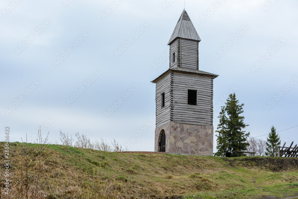 Fototapeta premium Tetyushi, Tatarstan - May 2, 2019. A wooden observation tower on a high mountain on the coast of the Volga River. The tower is a copy of the tower built during the founding of the town Tetyushi.