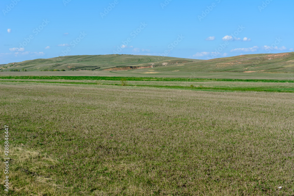 Beautiful spring landscape: trees, forest, mountains, hills, fields, meadows and blue sky. Beautiful spring landscape: trees, forest, mountains, hills, fields, meadows and blue sky.
