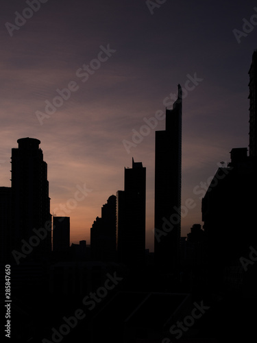 Bangkok skyline at sunset with violett Sky and Building in Shadow © Simon