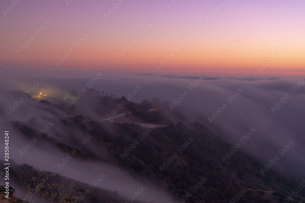 Obraz premium clouds flowing down the mountains like a river