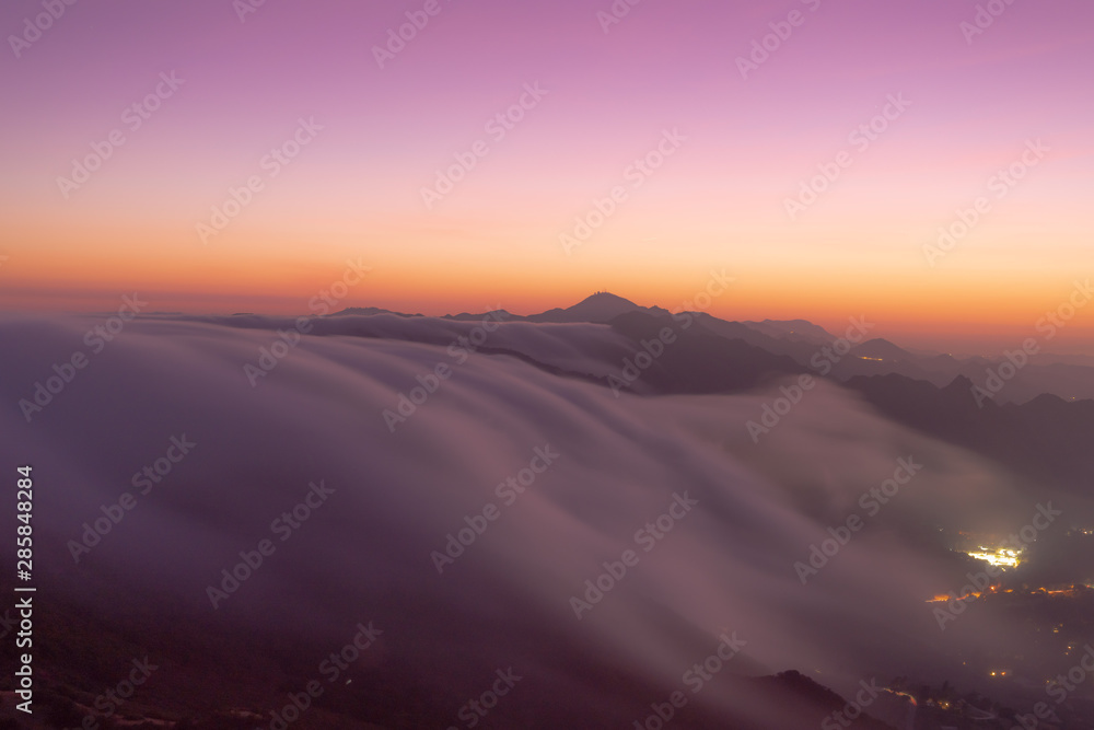 clouds flowing down the mountains like a river