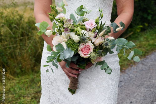 wedding flower bouquet in hands of bride