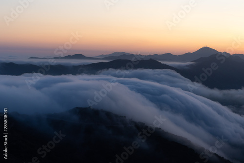 clouds flowing down the mountains like a river