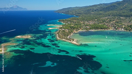 Aerial drone panoramic photo of iconic bay with turquoise frozen waves of Vourvourou in Sithonia Peninsula, Halkidiki, North Greece