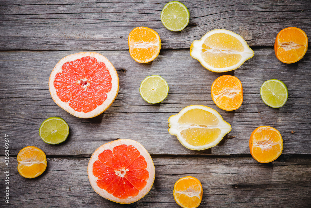 Assorted citrus fruit in a wooden box. Orange, tangerine, grapefruit, lemon. On a wooden background. Top view. Copy space. Assorted citrus fruit in a wooden box. Orange, tangerine, grapefruit, lemon. On a wooden background. Top view. Copy space.