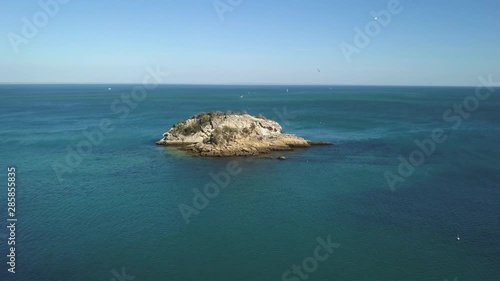 Serial view of a small island in Praia portinho da Arrábida in Portugal photo