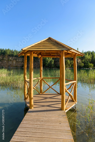 Wooden bower on the pond in Grodek park in Jaworzno