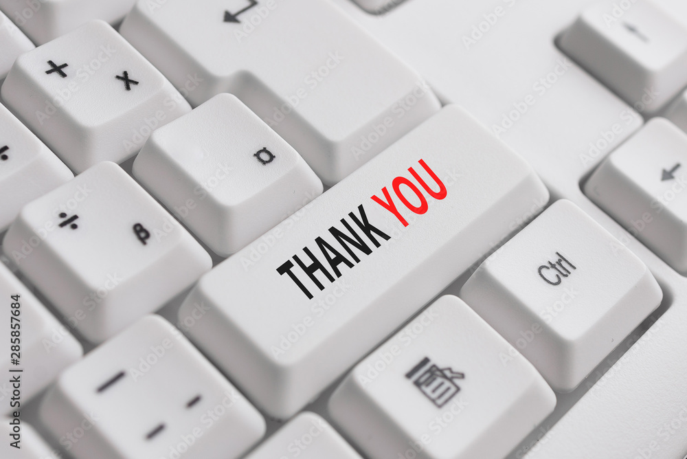 Writing note showing Thank You. Business concept for a polite expression used when acknowledging a gift or service White pc keyboard with note paper above the white background Writing note showing Thank You. Business concept for a polite expression used when acknowledging a gift or service White pc keyboard with note paper above the white background