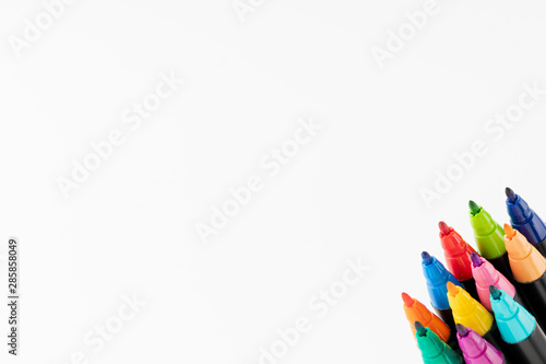 Felt-tip pens with the cap removed in the lower right corner with a white background. Back to school