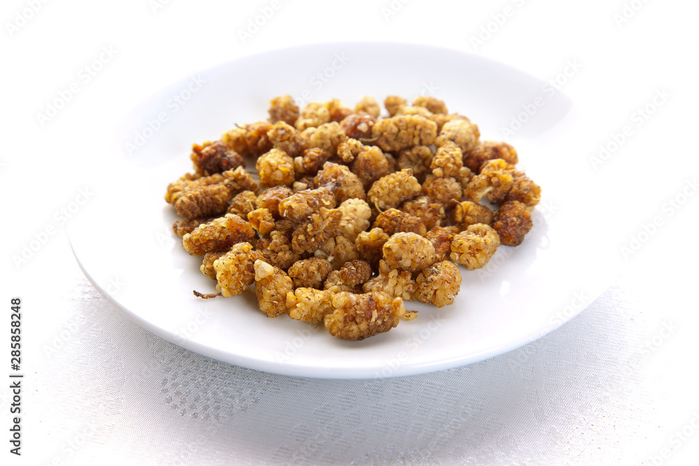 dried mulberry on plate on white background dried mulberry on plate on white background