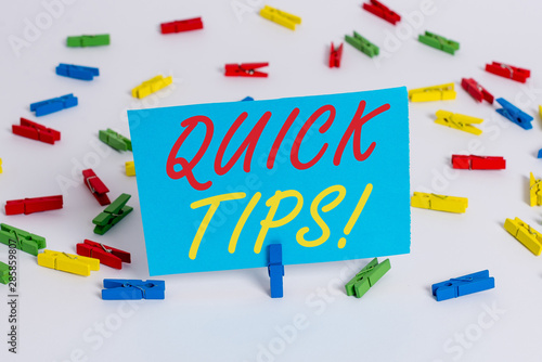 Text sign showing Quick Tips. Business photo text small but particularly useful piece of practical advice Colored clothespin papers empty reminder white floor background office