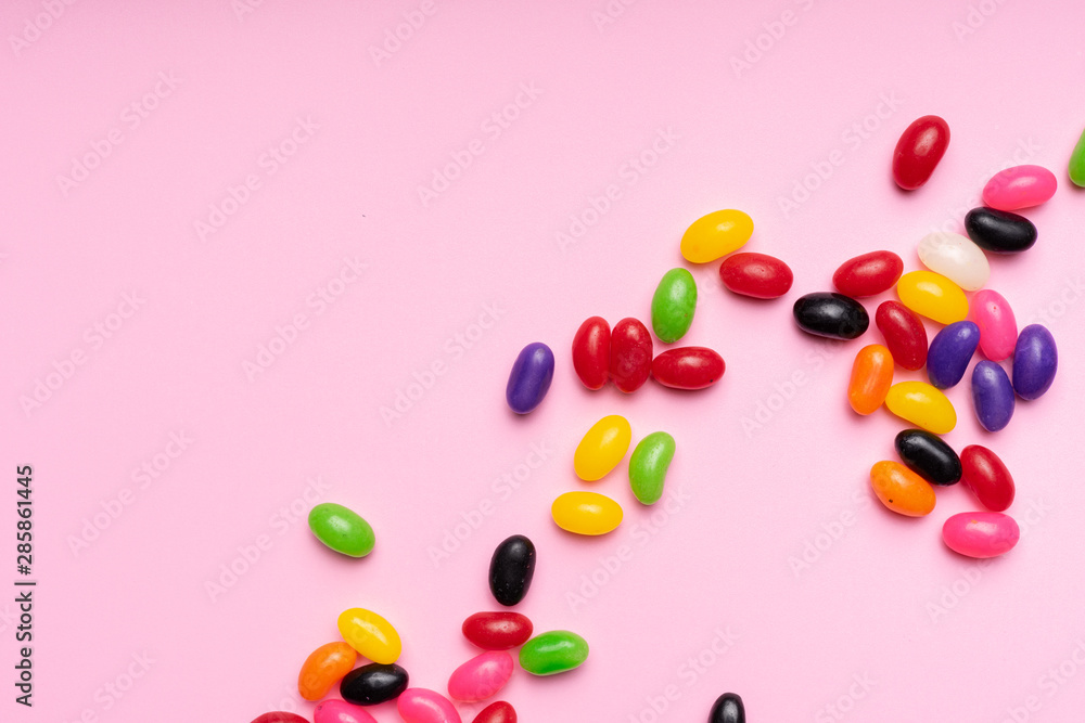 colourful jelly beans candies pink background Top view colourful jelly beans candies pink background Top view