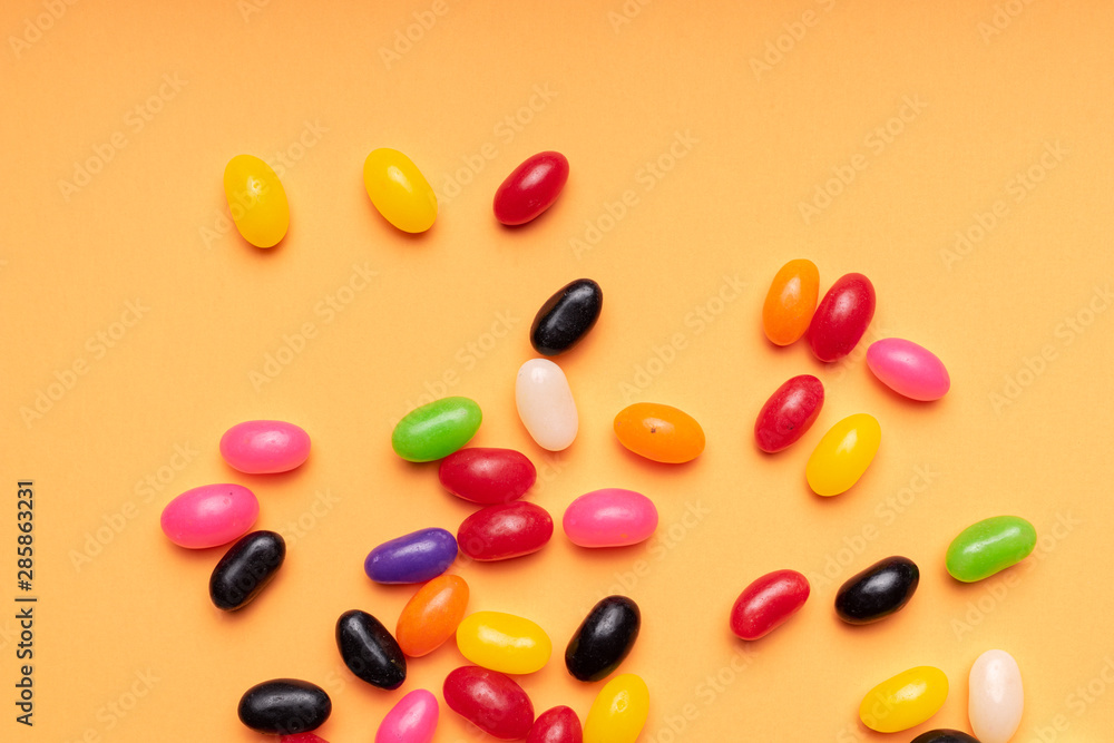 colourful jelly beans candies orange background Top view colourful jelly beans candies orange background Top view