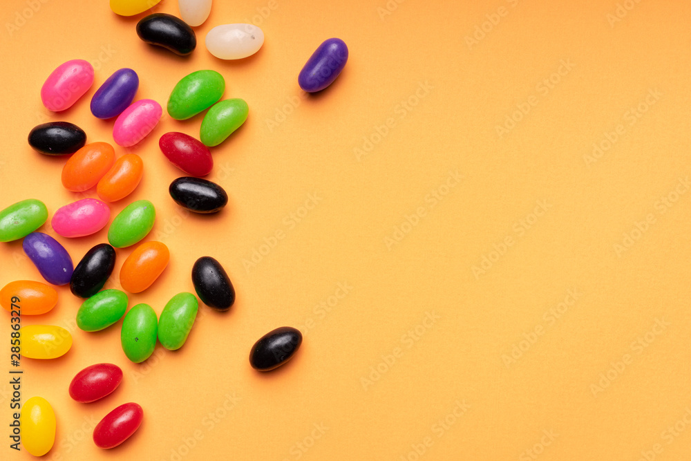 colourful jelly beans candies orange background Top view colourful jelly beans candies orange background Top view
