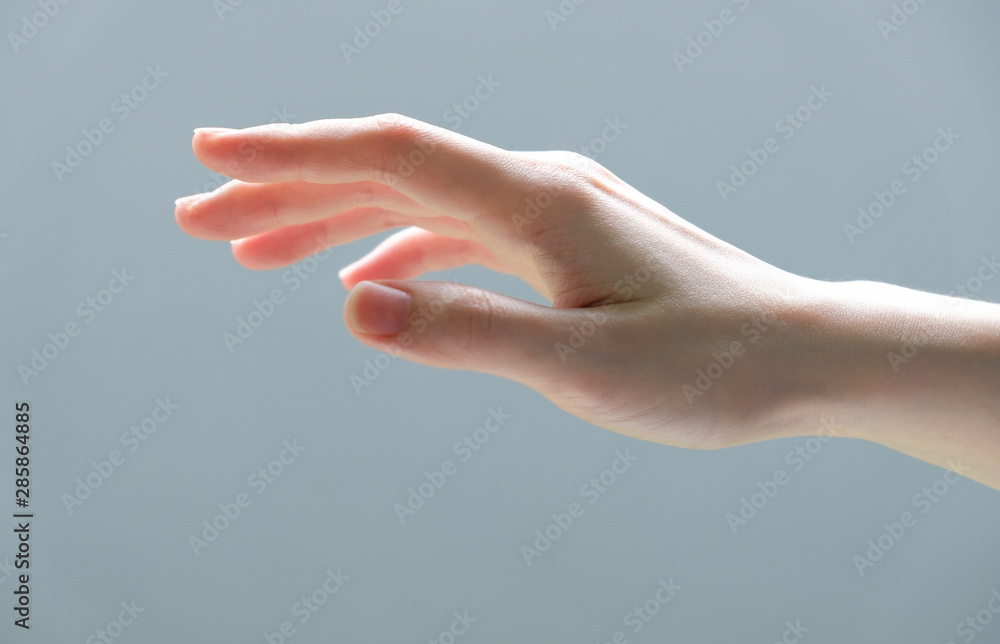 Young woman hand reaching out for touch someting