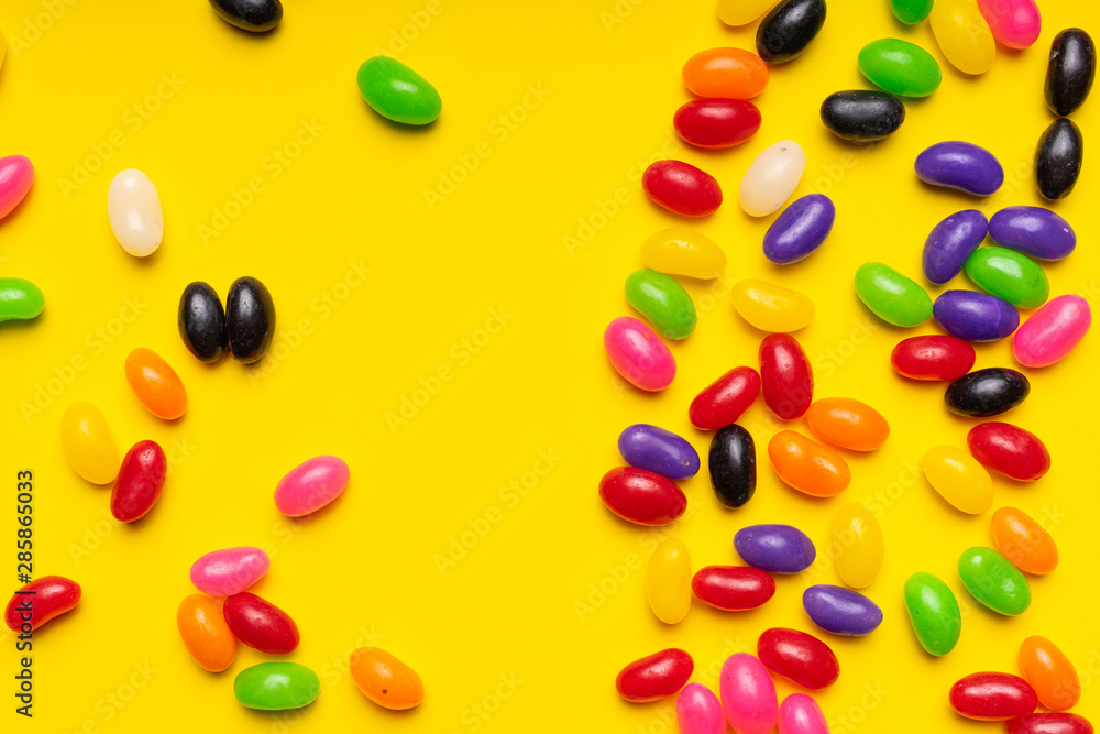 colourful jelly beans candies yellow background Top view colourful jelly beans candies yellow background Top view
