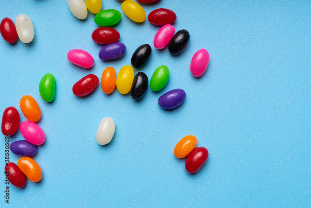 colourful jelly beans candies blue background Top view colourful jelly beans candies blue background Top view