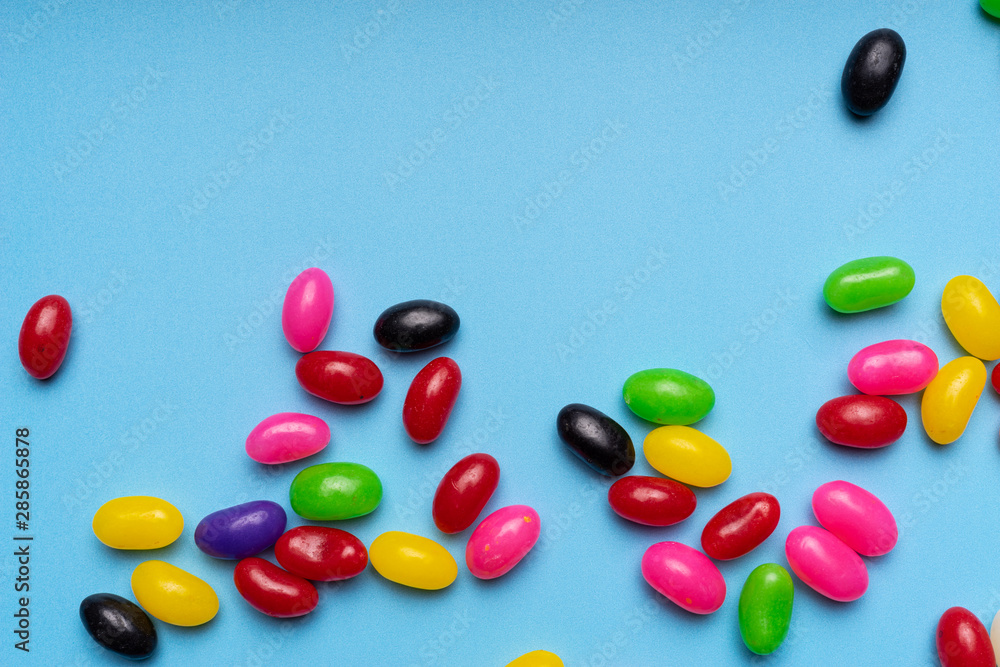 colourful jelly beans candies blue background Top view colourful jelly beans candies blue background Top view