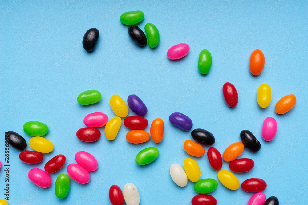 colourful jelly beans candies blue background Top view colourful jelly beans candies blue background Top view