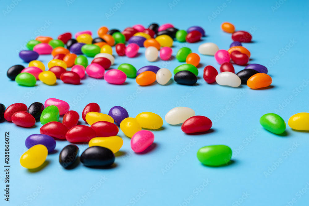 colourful jelly beans candies blue background Top view colourful jelly beans candies blue background Top view