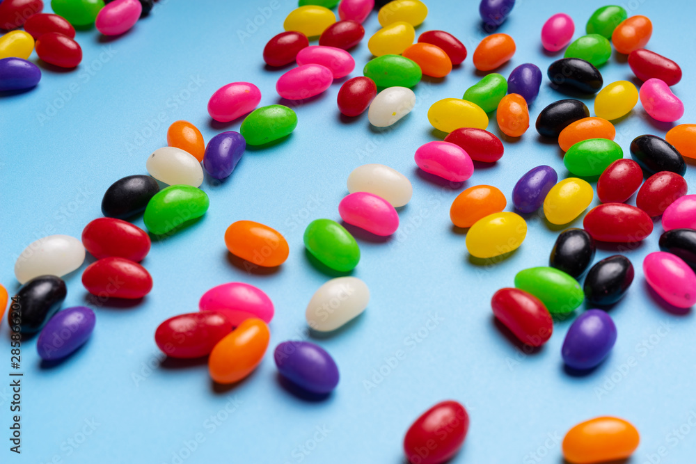 colourful jelly beans candies blue background Top view colourful jelly beans candies blue background Top view