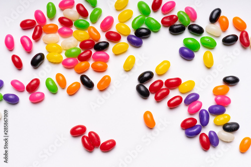 Fototapeta Naklejka Na Ścianę i Meble -  colorful jelly beans candies white background Top view