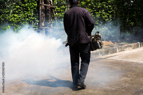 Man using smoke machine for pest control