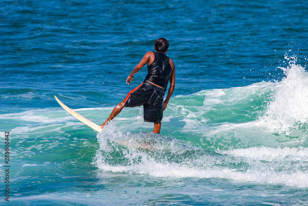 Ecuador. The Village Of Montanita. Pacific ocean. Longboard surfer. Athlete waiting for waves. The surfer is getting ready to perform the trick. Learning to surf. Active holidays in Ecuador. Ecuador. The Village Of Montanita. Pacific ocean. Longboard surfer. Athlete waiting for waves. The surfer is getting ready to perform the trick. Learning to surf. Active holidays in Ecuador.